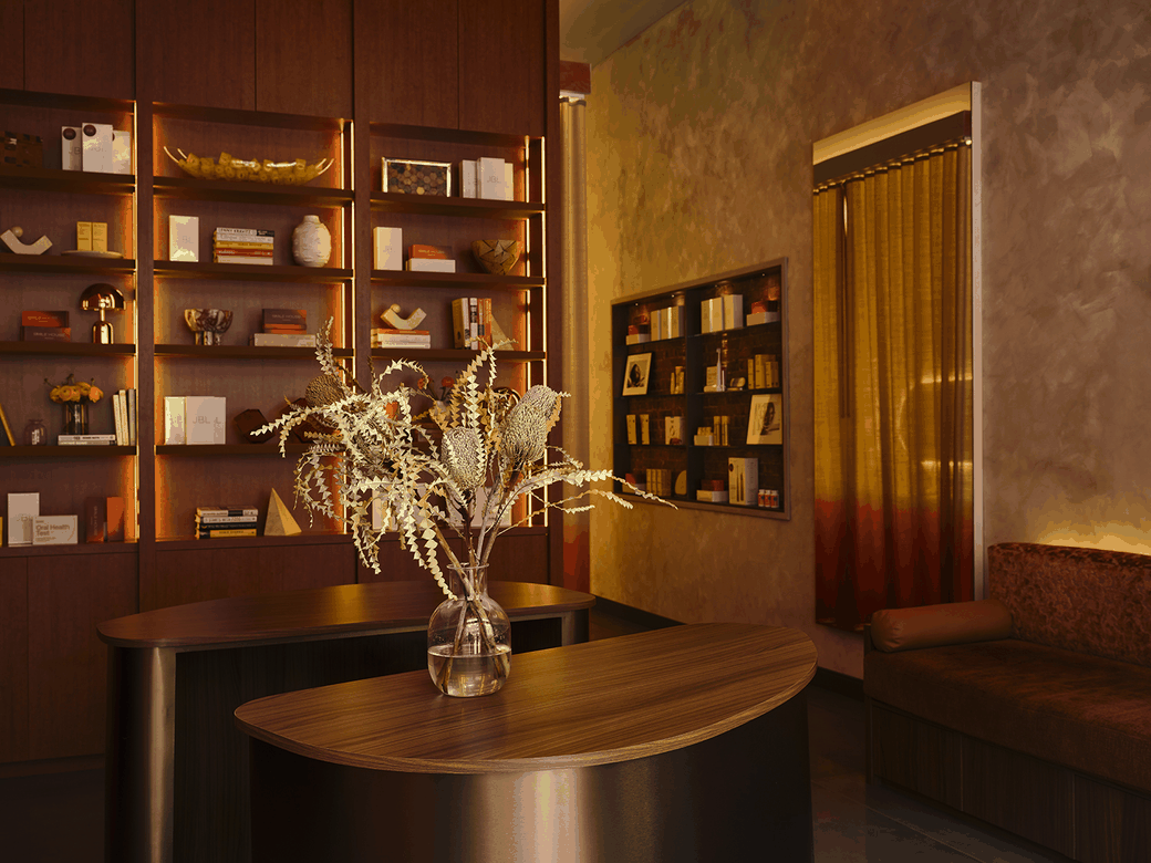 La recepción de Smile House: un mostrador curvo de madera con un arreglo de ramas secas, estantería iluminada con objetos y libros, muros texturizados en tonos tierra, cortina dorada y un sillón bajo. Se parece más al lobby de un hotel que a la entrada de un consultorio dental.